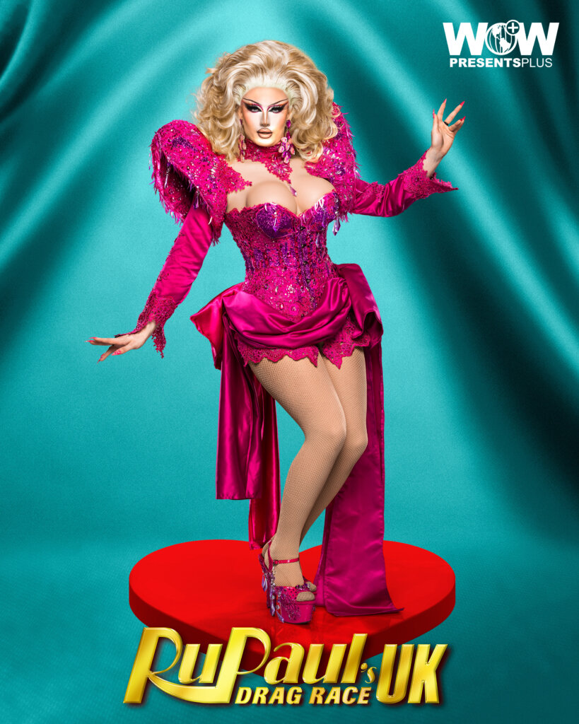 DeDeLicious posing for RuPaul's Drag Race UK series 5 promo for Meet The Queens in a pink outfit.
