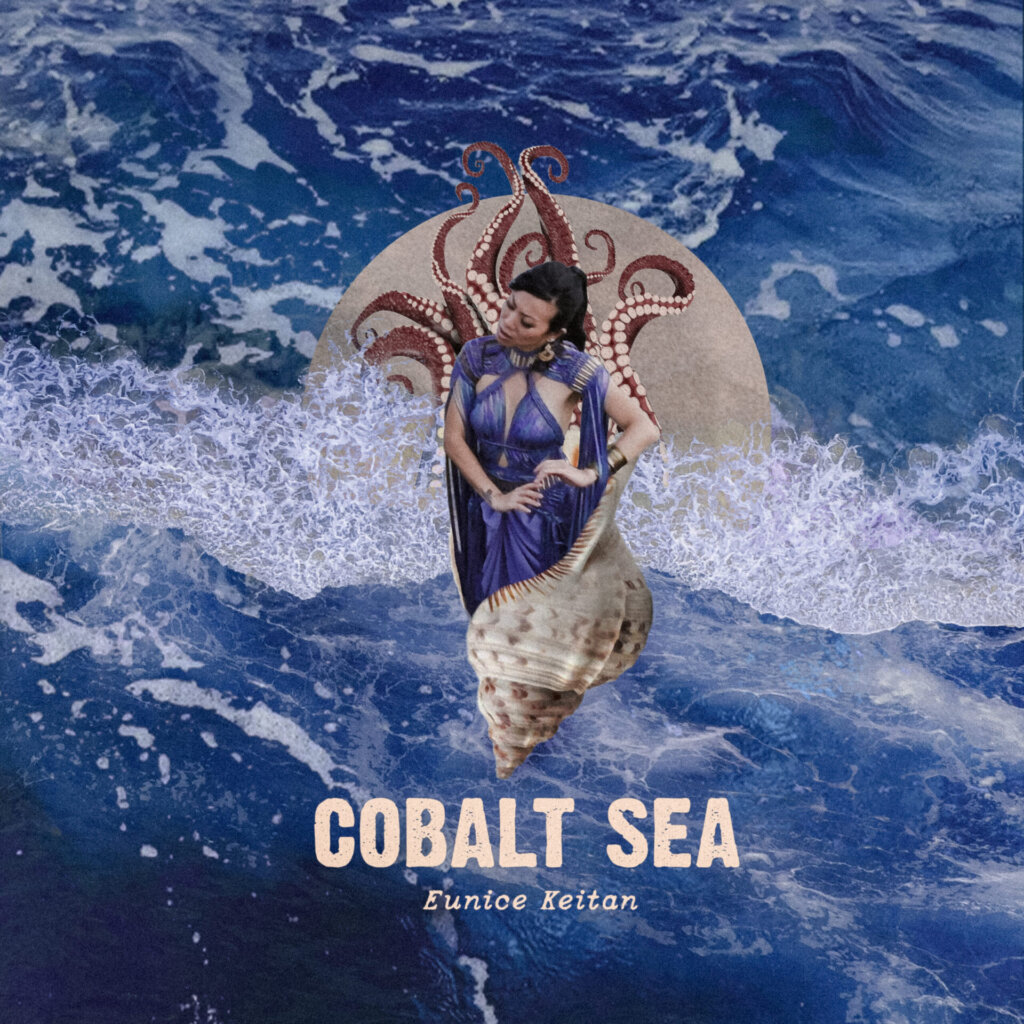 Single cover artwork for "Cobalt Sea" which sees Eunice Keitan wrapped in a shell surrounded by ocean waves.