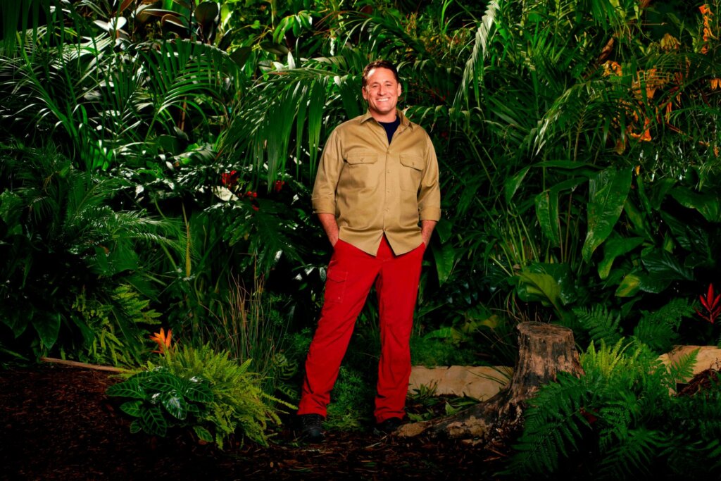 Promotional photo for I'm A Celebrity... Get Me Out Of Here! 2023, which sees Nick Pickard in a jungle setting, wearing the camp uniform.