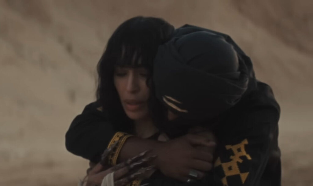 Still from the "Is It Love" music video which sees Loreen being embraced by her love-interest, calming her anxiety around whether it is love or not.