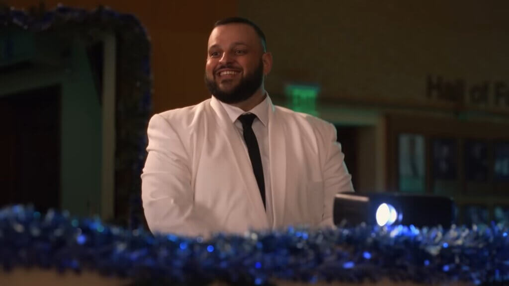 Still from Walmart's Mean Girls reunion advert which sees Daniel Franzese controlling the lights at the Winter show.