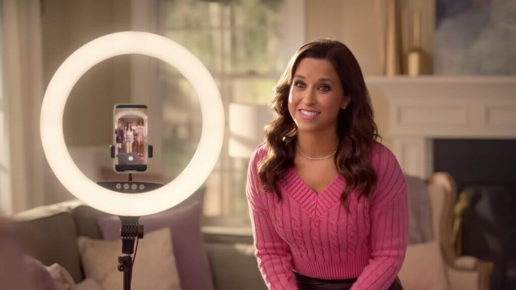 Still from Walmart's Mean Girls reunion advert which sees Lacey Chabert standing next to a ring light as he daughter and friends record a Tiktok.
