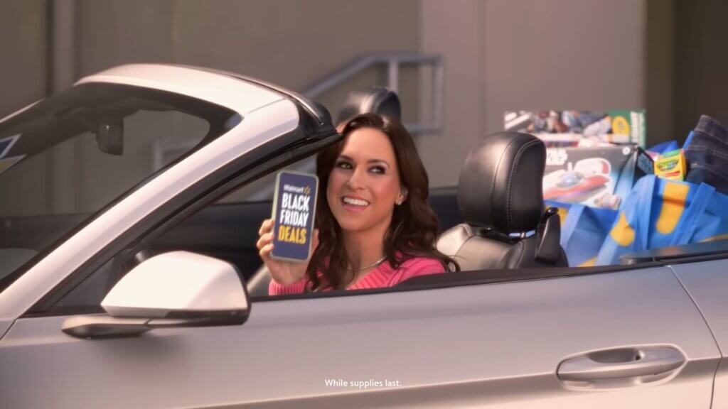 Still from Walmart's Mean Girls reunion advert which sees Lacey Chabert driving a convertible car.