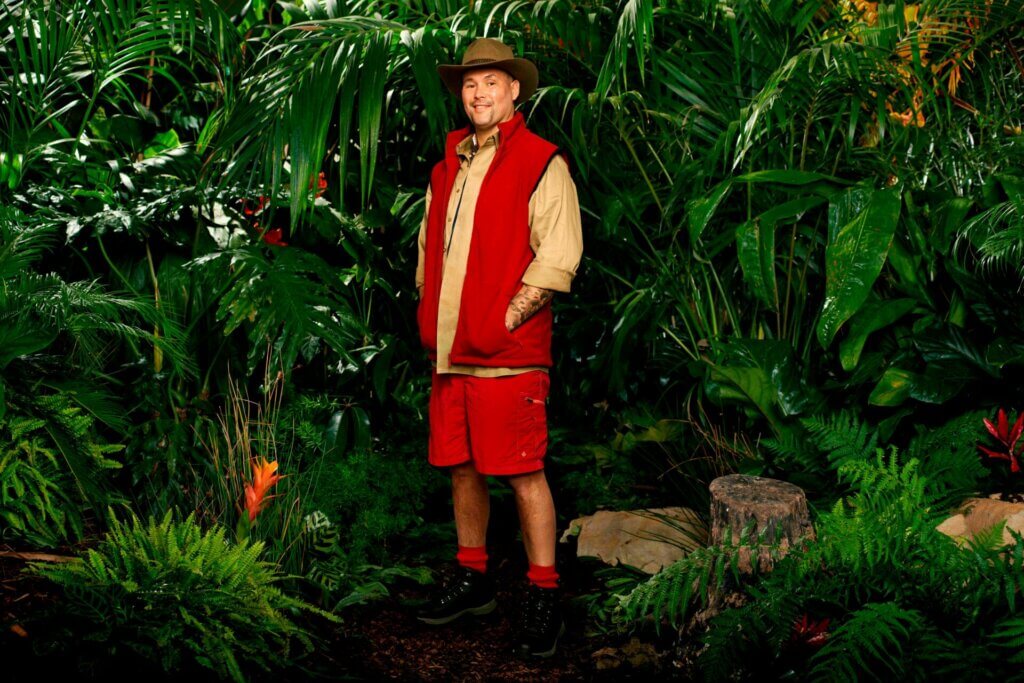 Promotional photo for I'm a Celebrity… Get Me Out of Here! 2023, which sees Tony Bellew in a jungle setting, wearing the camp uniform.
