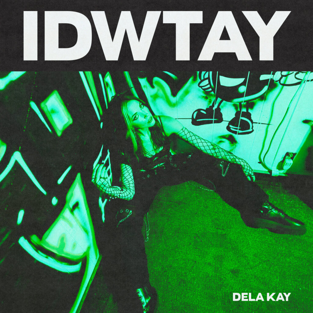 Official single cover artwork for "IDWTAY" which sees Dela Kay sitting in a corner with two graffiti walls and a green filter over her.