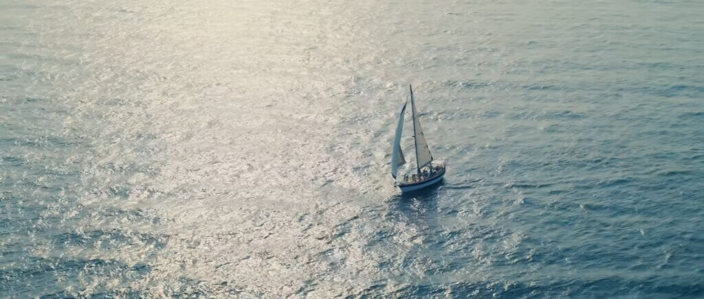 Scene from the "I GOT YOU" music video which sees the boat sailing away across the sea.
