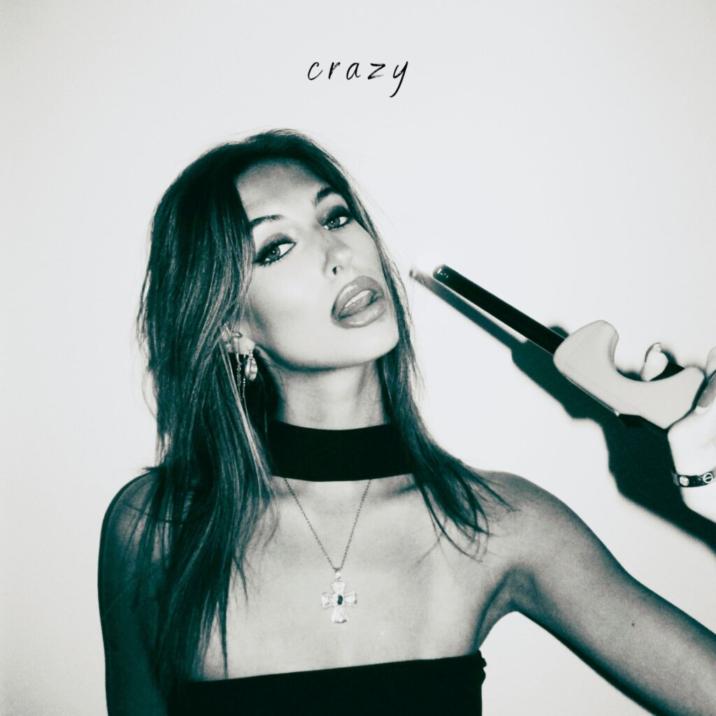 Official cover artwork for "Crazy" which sees a black and white head shot of Liv Hanna holding a lighter to her face.