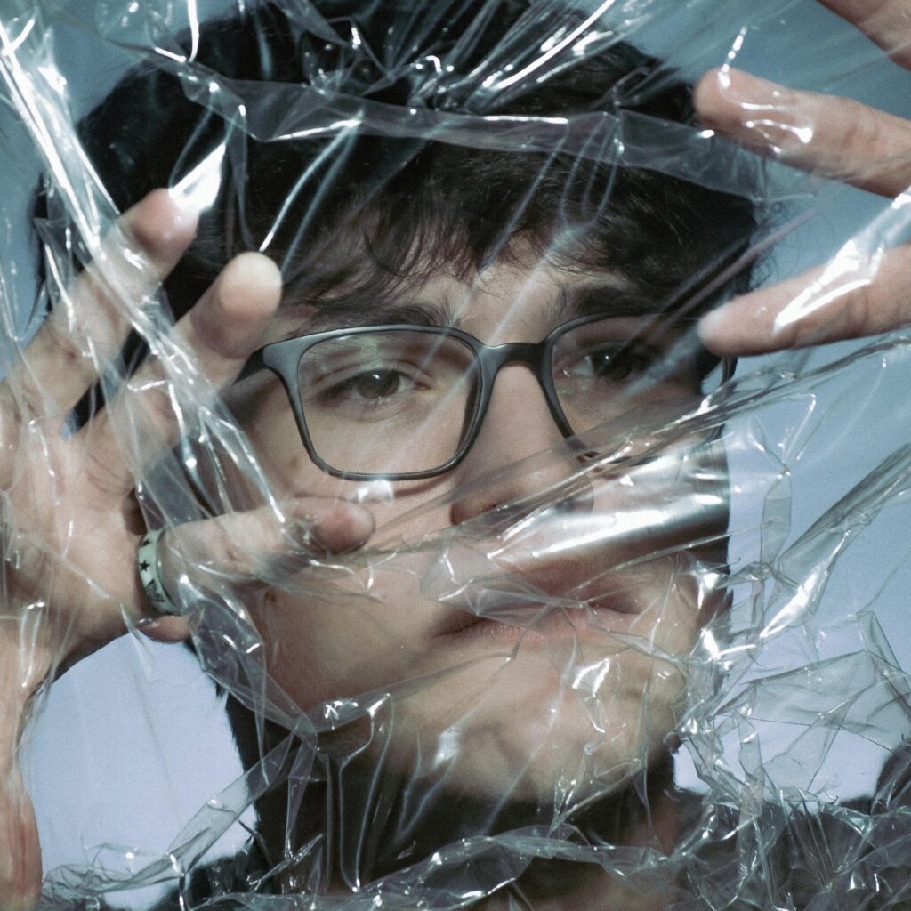 Official single cover artwork for "Half of You" which sees a head shot of Rob Eberle with a plastic sheet over his face.
