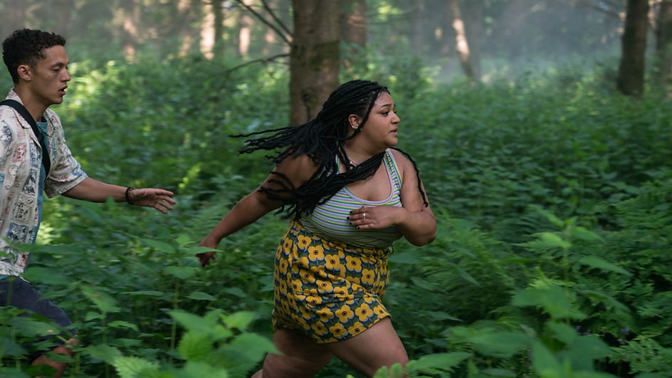 Still from Wreck TV show that sees Lauren (Amber Grappy) and Ben (Orlando Norman) running in fear in a forest.