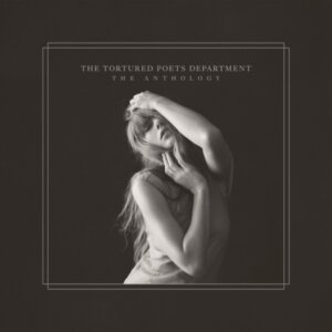 Official album artwork for "The Tortured Poets Department: The Anthology" which sees a dark cover with a black and white photo of Taylor Swift