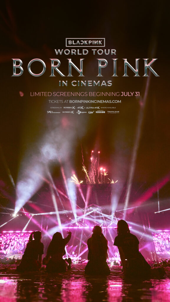 Official vertical poster for the "BLACKPINK WORLD TOUR [BORN PINK] IN CINEMAS" film which sees the four-piece girl group, BLACKPINK, sitting on the floor of the stage, silhouetted by shadows as spotlights beam upwards in pink.