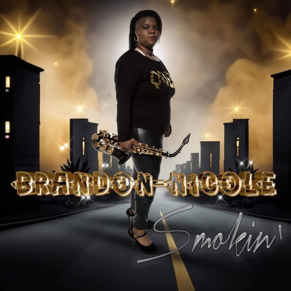Official single cover artwork of "Smokin'" which sees Brandon-Nicole standing in the middle of a road with buildings staggered on either side, wearing black and holding a saxophone.