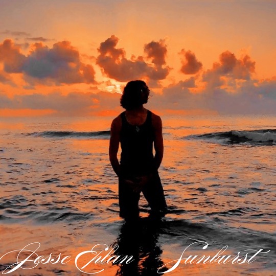 The official single cover artwork of "Sunburst" which sees Jesse Eplan wading in the water with the sun setting behind him and the title of the song in handwriting text.