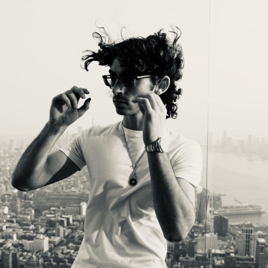 Black and white photo of Jesse Eplan with New York city scape behind him/