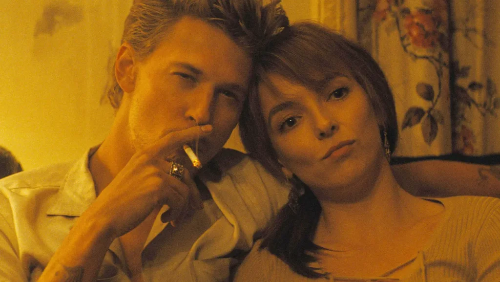 Austin Butler and Jodie Comer as Billy and Kathy, cuddled up together with Billy's arm around her shoulders while he smokes a cigarette.