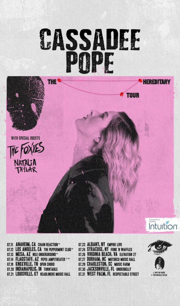 Official tour poster for Cassadee Pope's "Hereditary" tour, which sees her facing side-on with the colours stripped back to pink and black. The dates appear below the image.