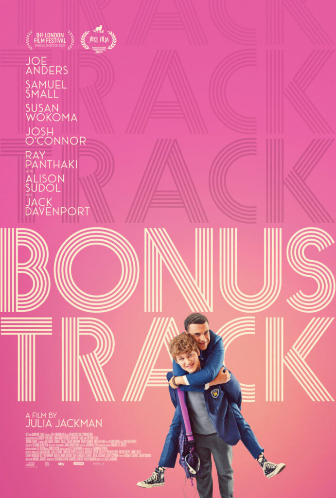 The bright pink film poster for Bonus Track which sees the boys piggy-backing.