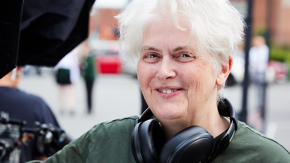 Promotional image for "Riot Women" which sees a photo of Sally Wainwright smiling at the camera.