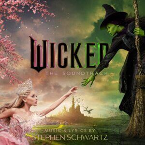 Official album artwork for Wicked: The Soundtrack which sees Ariana Grande as Glinda reaching out her hand to the hand of Cynthia Erivo as Elphaba.