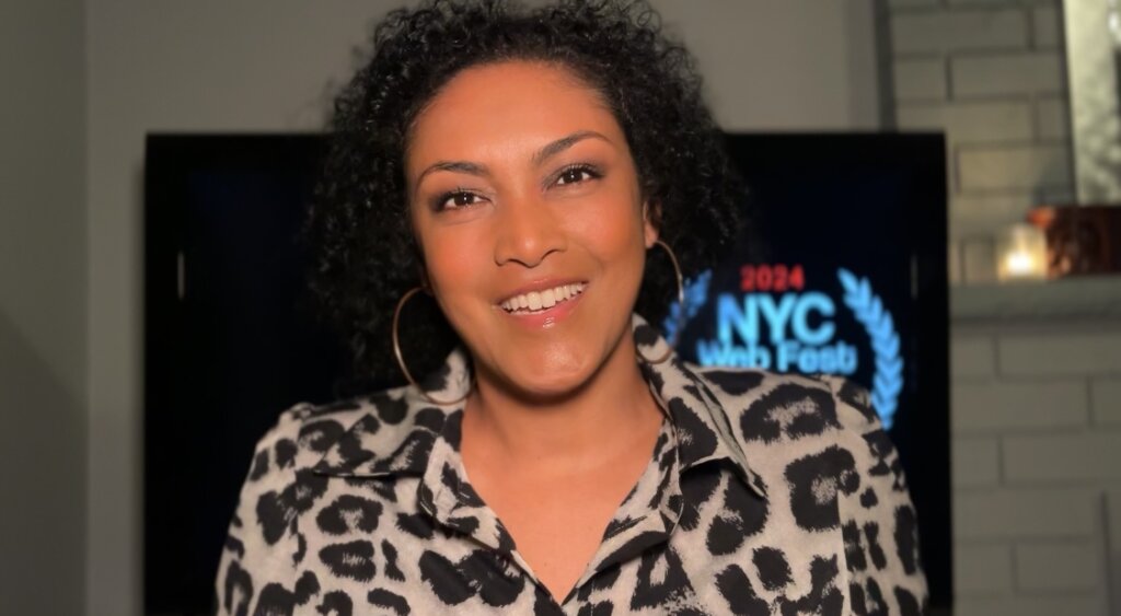 Founder of the NYC Web Fest, Lauren Atkins wearing an animal-print shirt and appearing at the festival virtually.