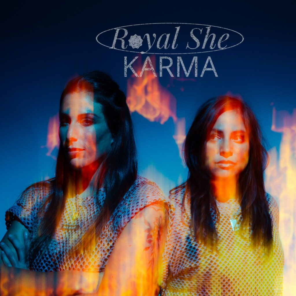 Official single cover artwork for "Karma" which sees Royal She posing together with their logo and the title above their heads, illuminated in a fire-like glow.