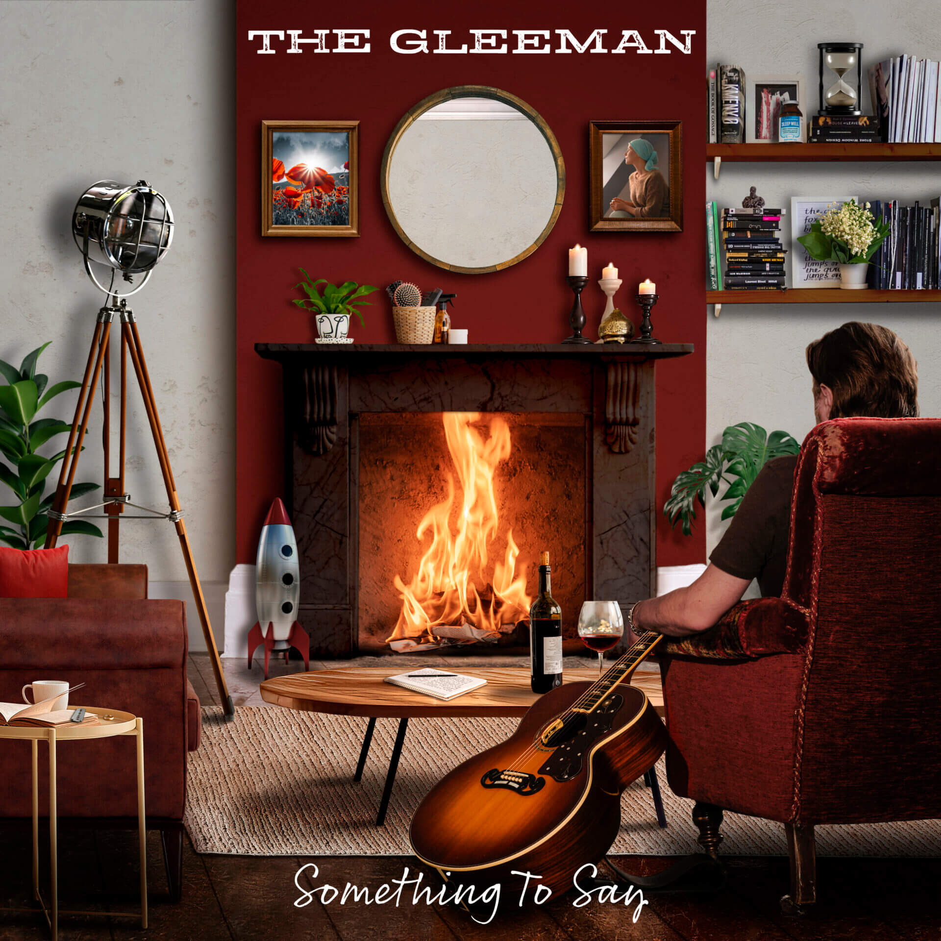 Official album cover artwork of "Something to Say" which sees The Gleeman with his back to us, sitting in a red armchair looking at a fireplace with a huge fire raging inside with a bottle of wine in front of him and his guitar to his side.