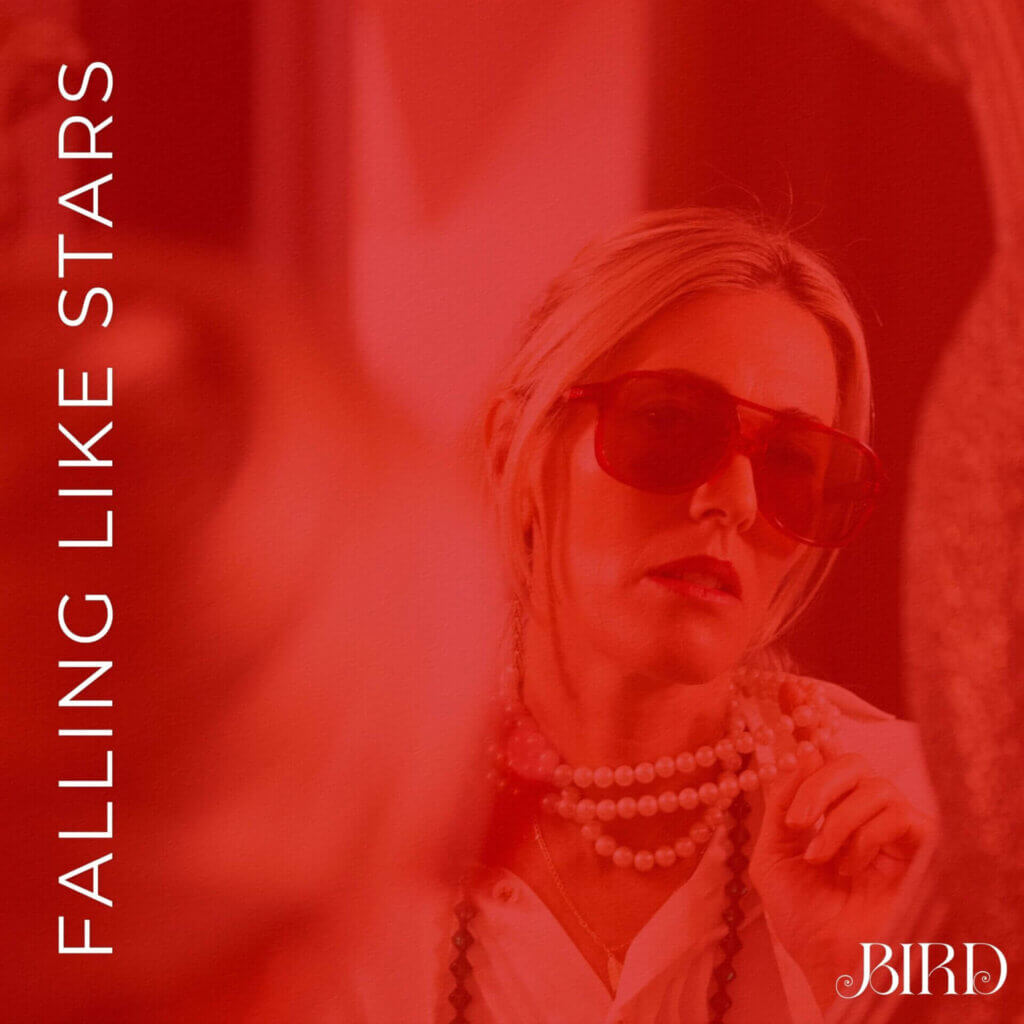 Official single cover artwork for "Falling Like Stars" which shows Bird looking in a mirror at herself wearing a cream blouse and red shades, while holding out her pearl-like necklace to the mirror. The entire image has a red filter over it.